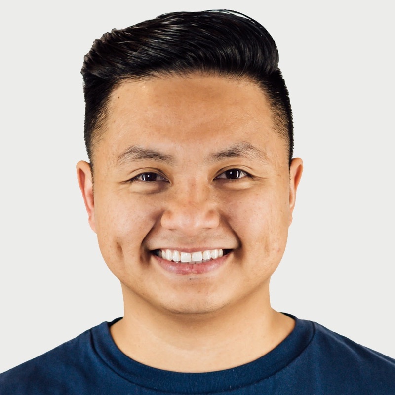 Portrait of Audy Arandela, smiling in a navy t-shirt
